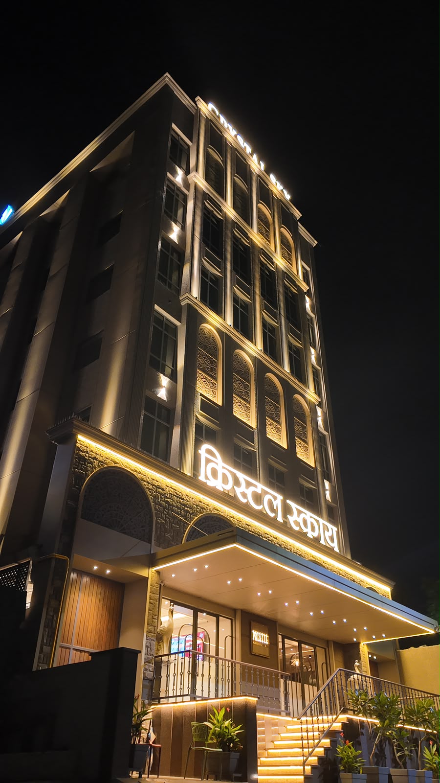 Crystal Sky Boutique Hotel building illuminated at night, full photograph
